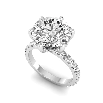 Round cut lab grown diamond solitaire engagement ring with pavé diamond band in white gold design.