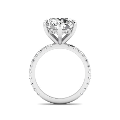 Round cut lab grown diamond solitaire engagement ring with pavé diamond band in white gold design.
