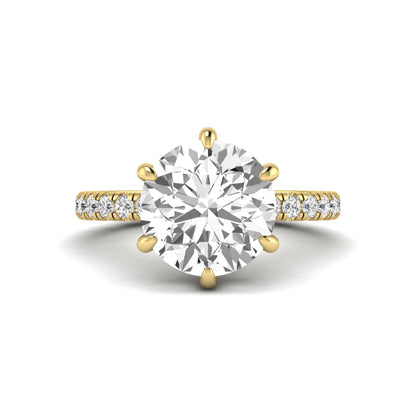 Round cut lab grown diamond solitaire engagement ring with pavé diamond band in yellow gold design.