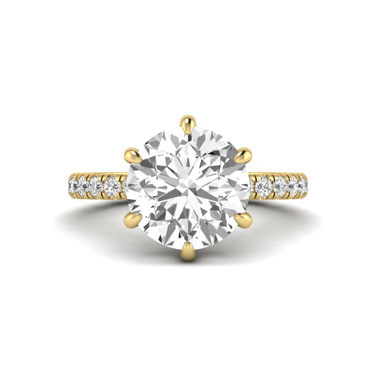 Round cut lab grown diamond solitaire engagement ring with pavé diamond band in yellow gold design.