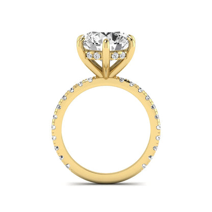 Round cut lab grown diamond solitaire engagement ring with pavé diamond band in yellow gold design.