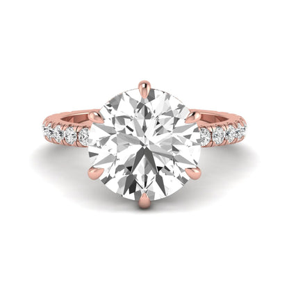 Round cut lab grown diamond solitaire engagement ring with pavé diamond band in rose gold design.