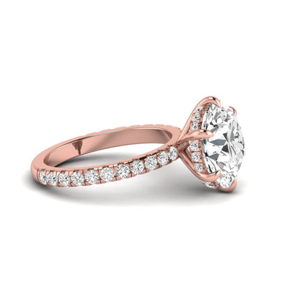 Round cut lab grown diamond solitaire engagement ring with pavé diamond band in rose gold design.