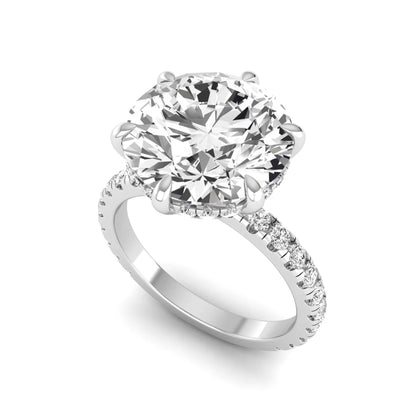 Round cut lab grown diamond solitaire engagement ring with pavé diamond band in white gold design.