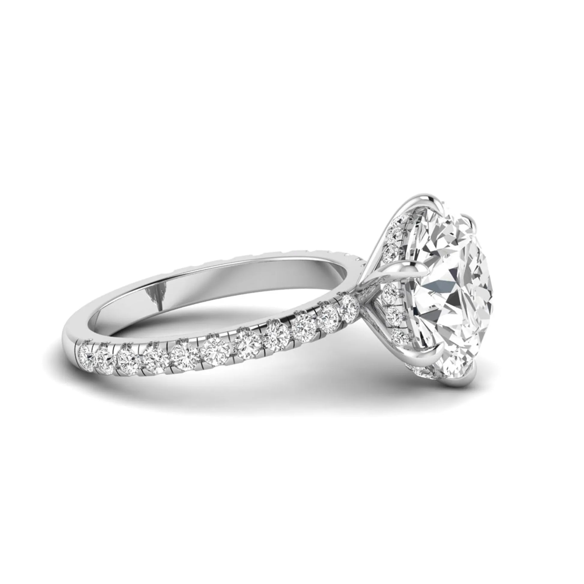 Round cut lab grown diamond solitaire engagement ring with pavé diamond band in white gold design.