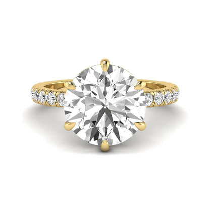 Round cut lab grown diamond solitaire engagement ring with pavé diamond band in yellow gold design.
