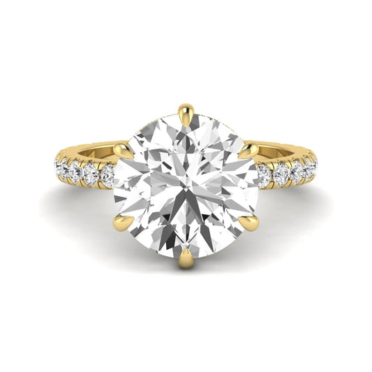Round cut lab grown diamond solitaire engagement ring with pavé diamond band in yellow gold design.