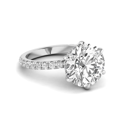 Round cut lab grown diamond solitaire engagement ring with pavé diamond band in white gold design.