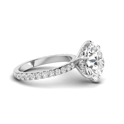 Round cut lab grown diamond solitaire engagement ring with pavé diamond band in white gold design.
