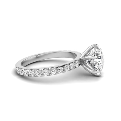 Round cut lab grown diamond solitaire engagement ring with pavé band in white gold design.