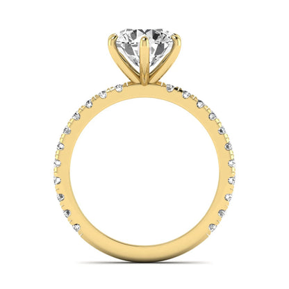 Round cut lab grown diamond solitaire engagement ring with pavé band in yellow gold design.