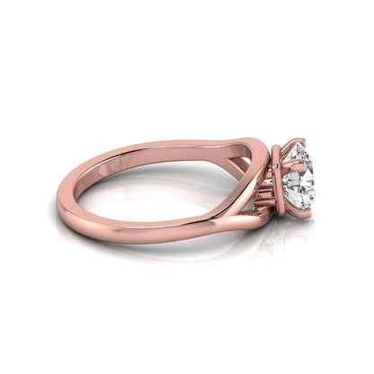 Round cut lab grown diamond solitaire engagement ring with split shank design in rose gold style.