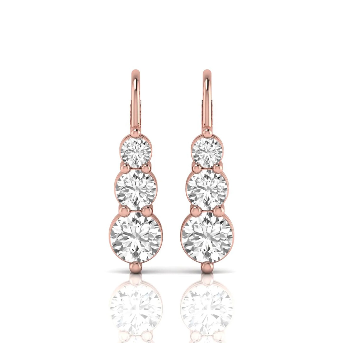 Round cut lab grown diamond graduated three stone drop earrings featuring a shared four-prong setting with secure lever back closure and rose gold tone design.