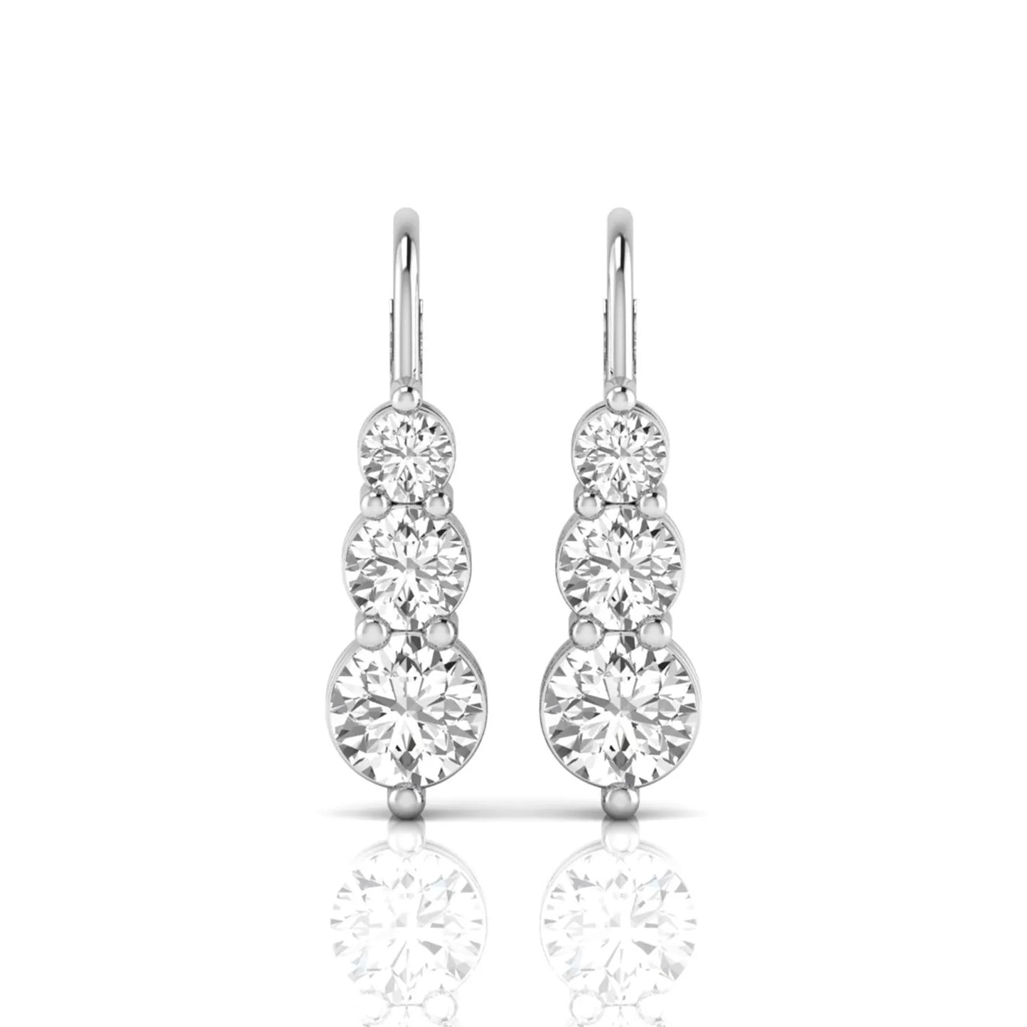 Round cut lab grown diamond graduated three stone drop earrings featuring a shared four-prong setting with secure lever back closure and white gold tone design.