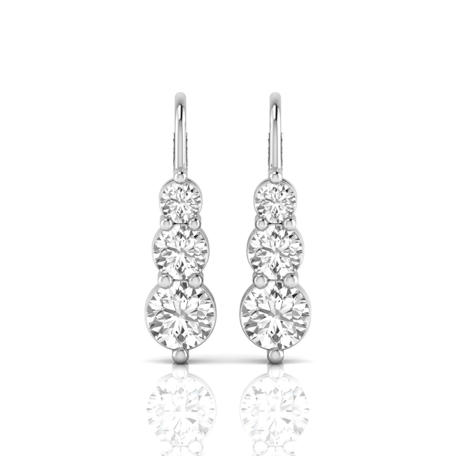 Round cut lab grown diamond graduated three stone drop earrings featuring a shared four-prong setting with secure lever back closure and white gold tone design.