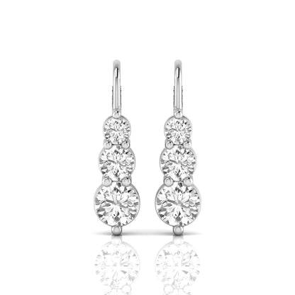 Round cut lab grown diamond graduated three stone drop earrings featuring a shared four-prong setting with secure lever back closure and white gold tone design.