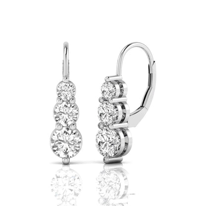 Round cut lab grown diamond graduated three stone drop earrings featuring a shared four-prong setting with secure lever back closure and white gold tone design.