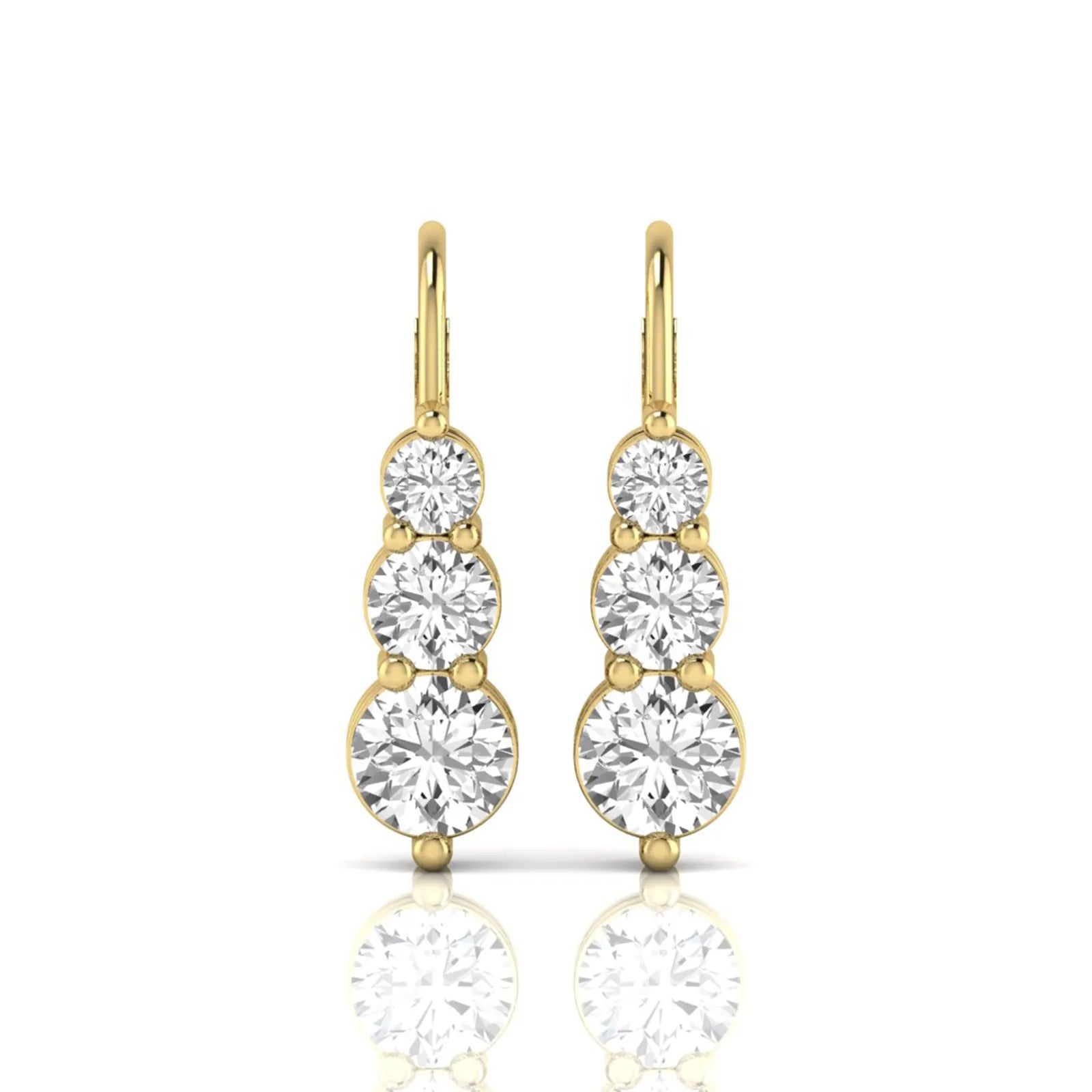 Round cut lab grown diamond graduated three stone drop earrings featuring a shared four-prong setting with secure lever back closure and yellow gold tone design.