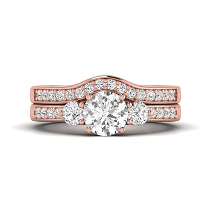 Round cut three stone lab grown diamond bridal ring set with matching diamond wedding band in rose gold featuring a 1.03 carat IGI certified center diamond.