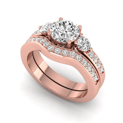 Round cut three stone lab grown diamond bridal ring set with matching diamond wedding band in rose gold featuring a 1.03 carat IGI certified center diamond.