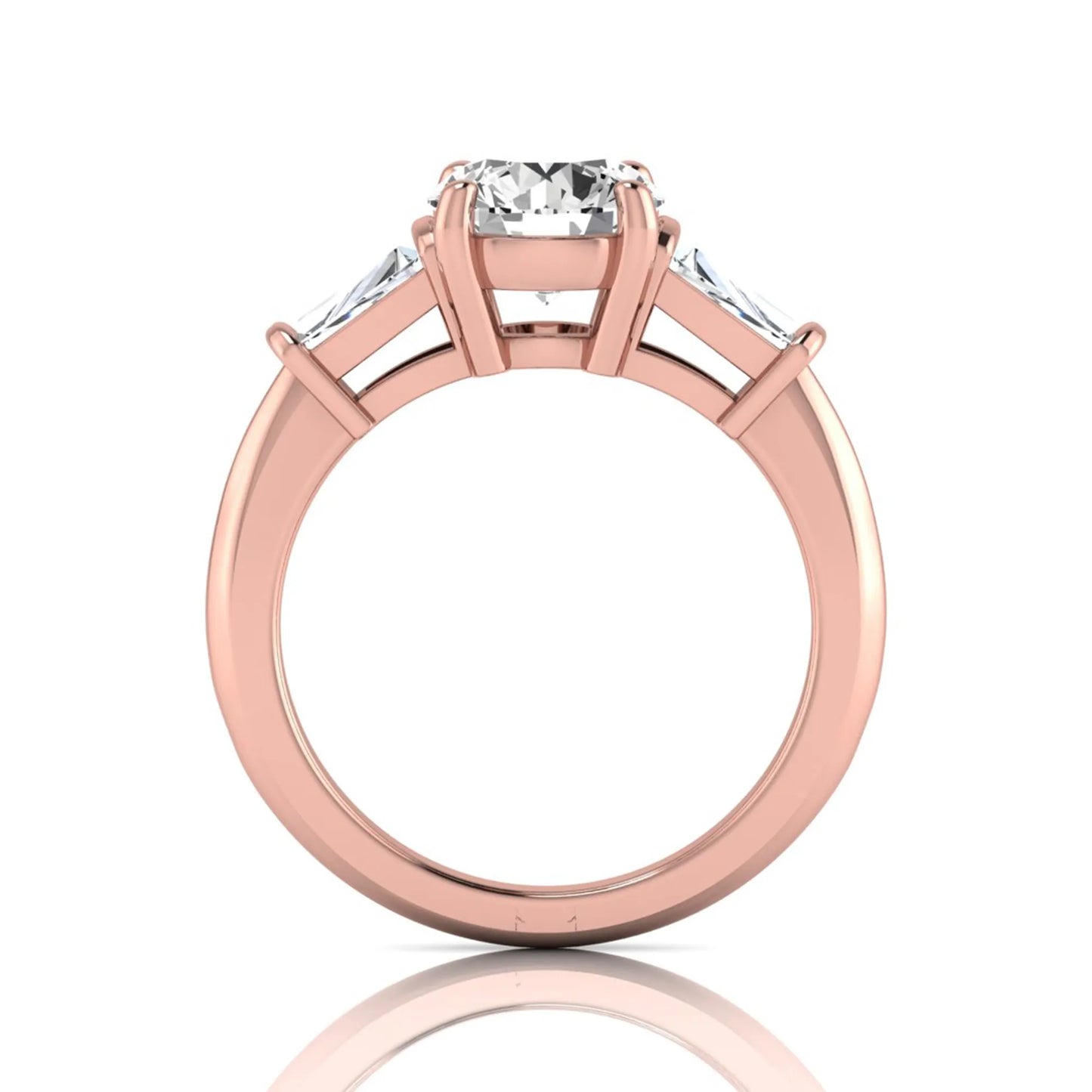 Round cut lab grown diamond three-stone engagement ring featuring tapered baguette side diamonds in a classic four-prong rose gold setting.