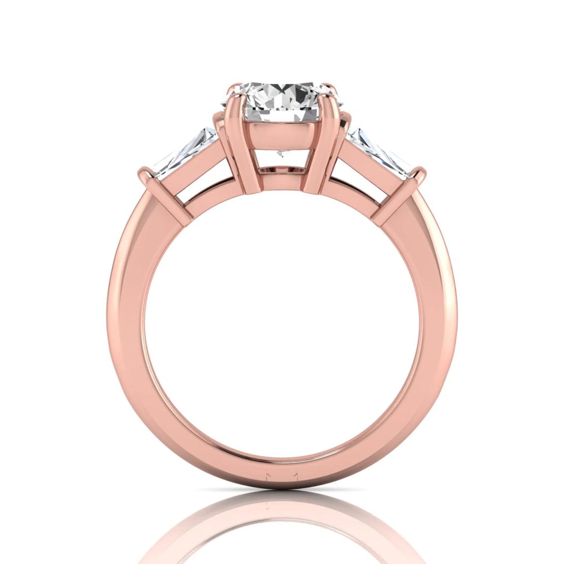 Round cut lab grown diamond three-stone engagement ring featuring tapered baguette side diamonds in a classic four-prong rose gold setting.