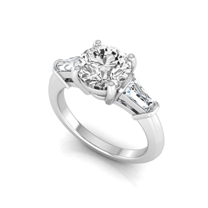 Round cut lab grown diamond three-stone engagement ring featuring tapered baguette side diamonds in a classic four-prong white gold setting.