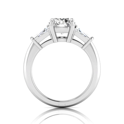 Round cut lab grown diamond three-stone engagement ring featuring tapered baguette side diamonds in a classic four-prong white gold setting.