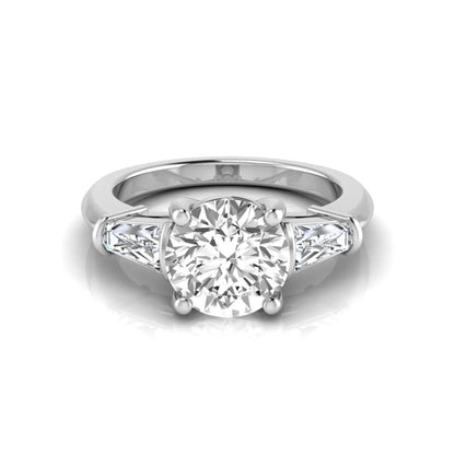 Round cut lab grown diamond three-stone engagement ring featuring tapered baguette side diamonds in a classic four-prong white gold setting.