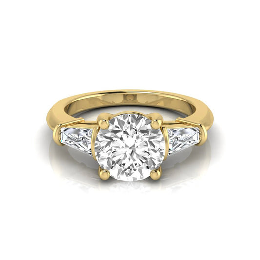 Round cut lab grown diamond three-stone engagement ring featuring tapered baguette side diamonds in a classic four-prong yellow gold setting.