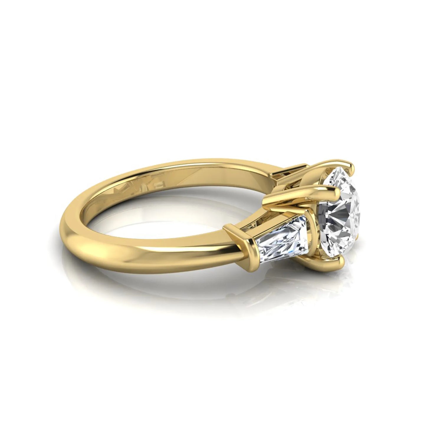 Round cut lab grown diamond three-stone engagement ring featuring tapered baguette side diamonds in a classic four-prong yellow gold setting.