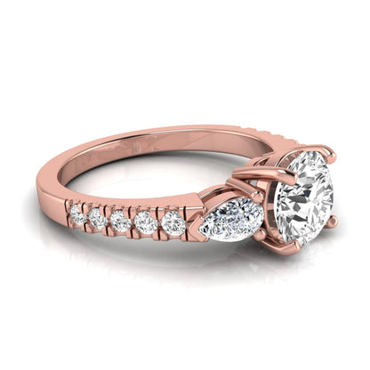 Round cut lab grown diamond three stone engagement ring featuring a 1.28 carat IGI certified center diamond with pear and round side diamonds on a pavé rose gold band.