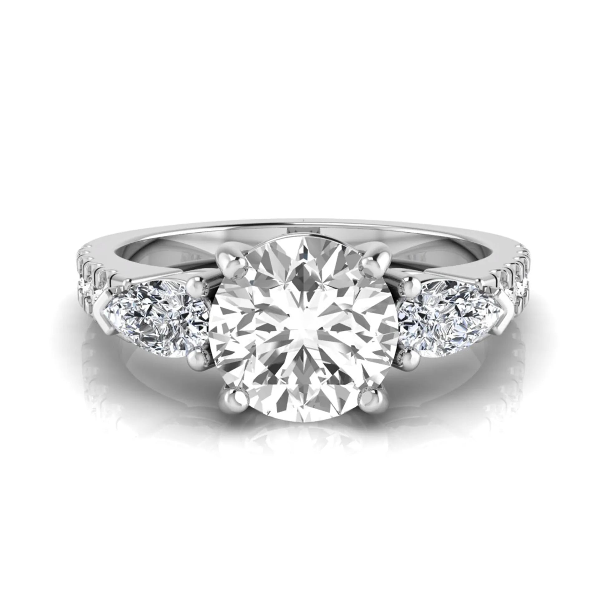 Round cut lab grown diamond three stone engagement ring featuring a 1.28 carat IGI certified center diamond with pear and round side diamonds on a pavé white gold band.