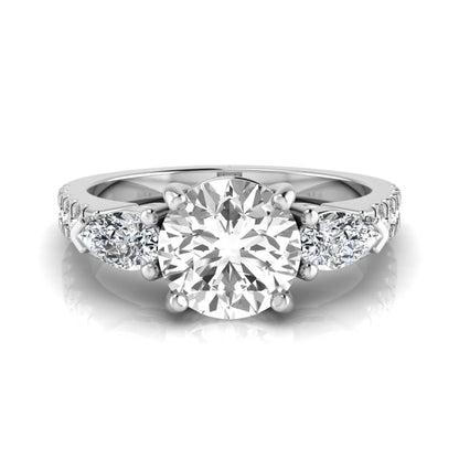 Round cut lab grown diamond three stone engagement ring featuring a 1.28 carat IGI certified center diamond with pear and round side diamonds on a pavé white gold band.
