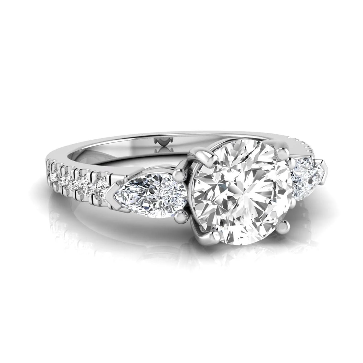 Round cut lab grown diamond three stone engagement ring featuring a 1.28 carat IGI certified center diamond with pear and round side diamonds on a pavé white gold band.