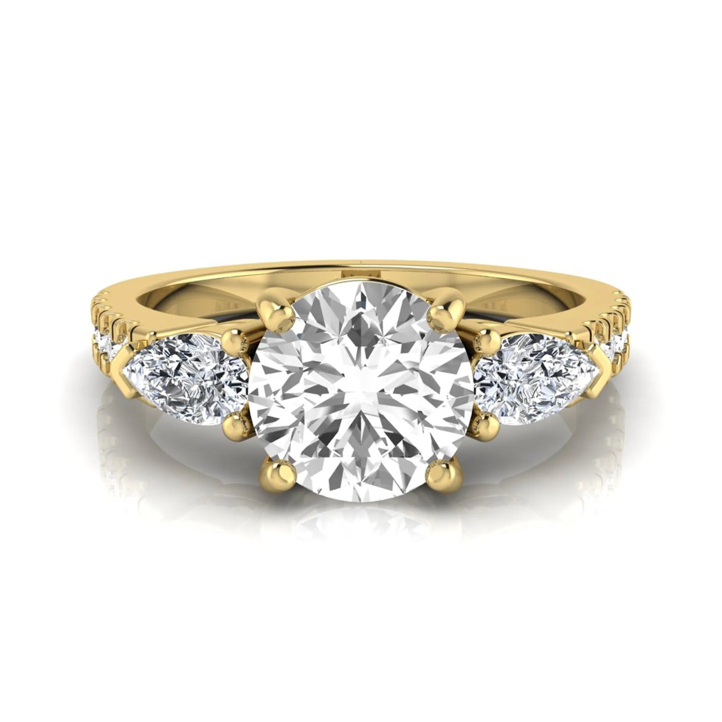 Round cut lab grown diamond three stone engagement ring featuring a 1.28 carat IGI certified center diamond with pear and round side diamonds on a pavé yellow gold band.