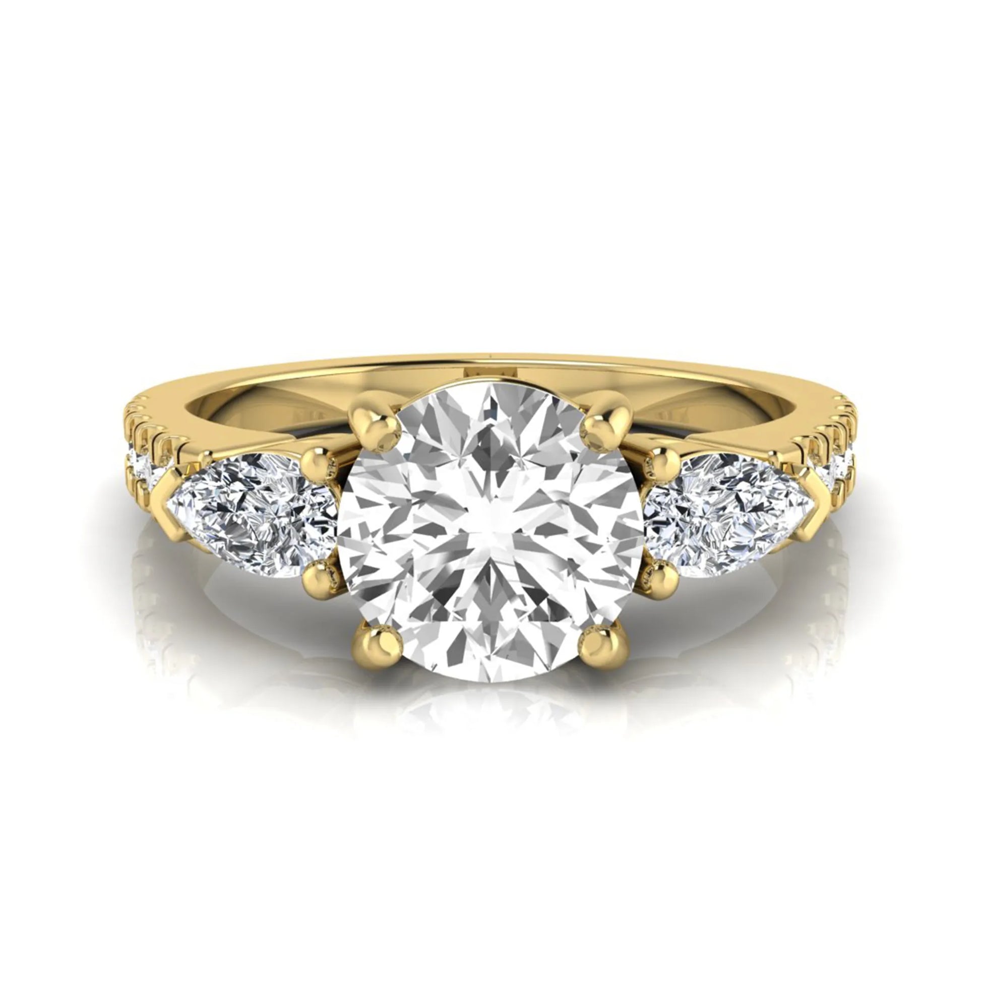 Round cut lab grown diamond three stone engagement ring featuring a 1.28 carat IGI certified center diamond with pear and round side diamonds on a pavé yellow gold band.