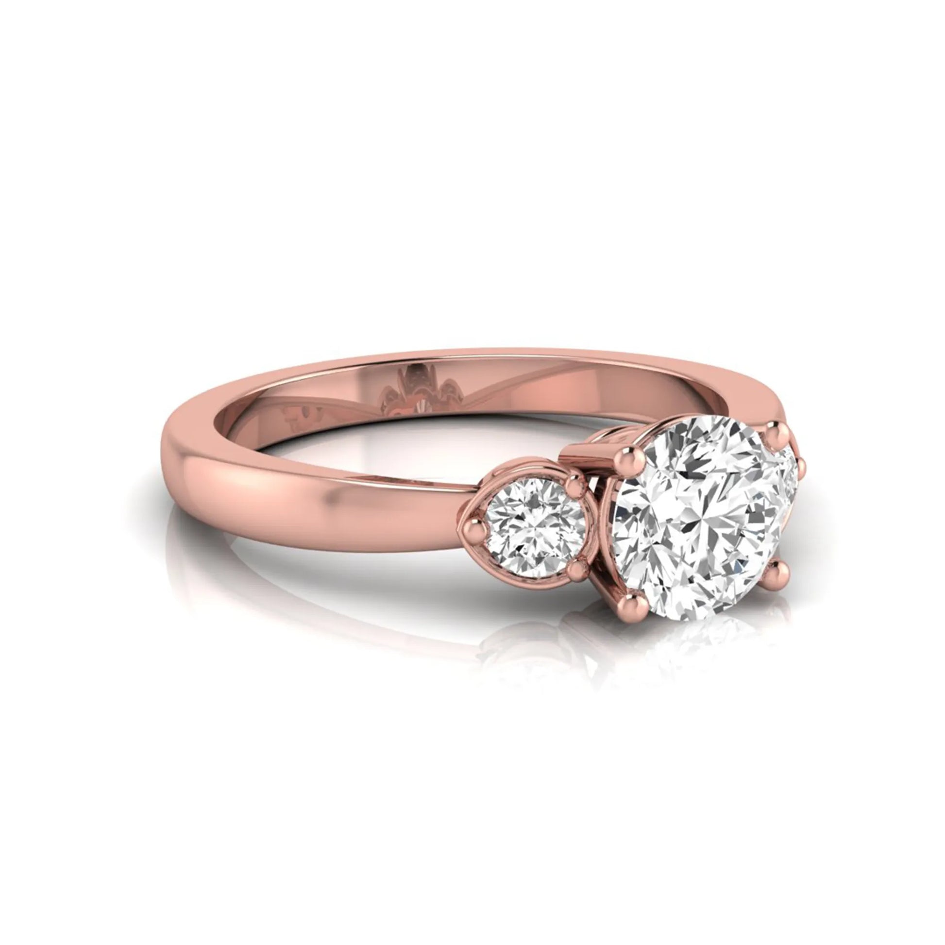 Round cut lab grown diamond three stone engagement ring featuring a brilliant center diamond with round side diamonds in a four-prong rose gold tone setting.