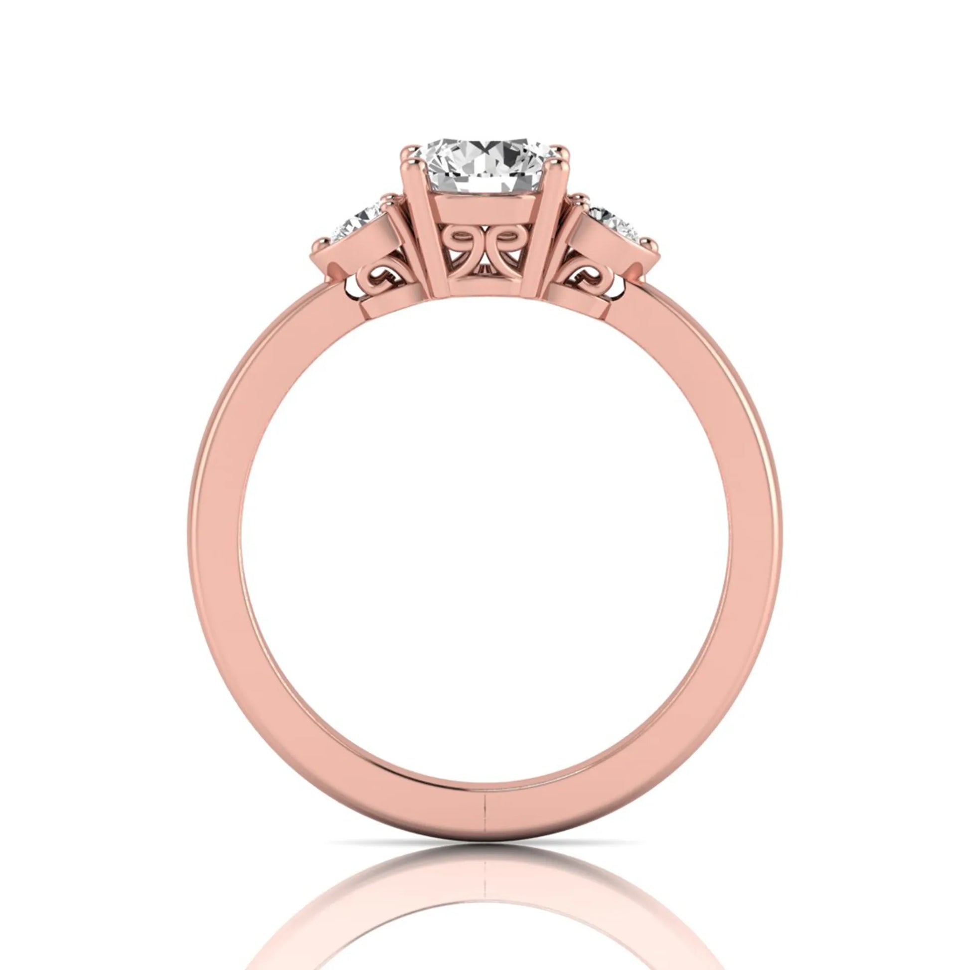 Round cut lab grown diamond three stone engagement ring featuring a brilliant center diamond with round side diamonds in a four-prong rose gold tone setting.