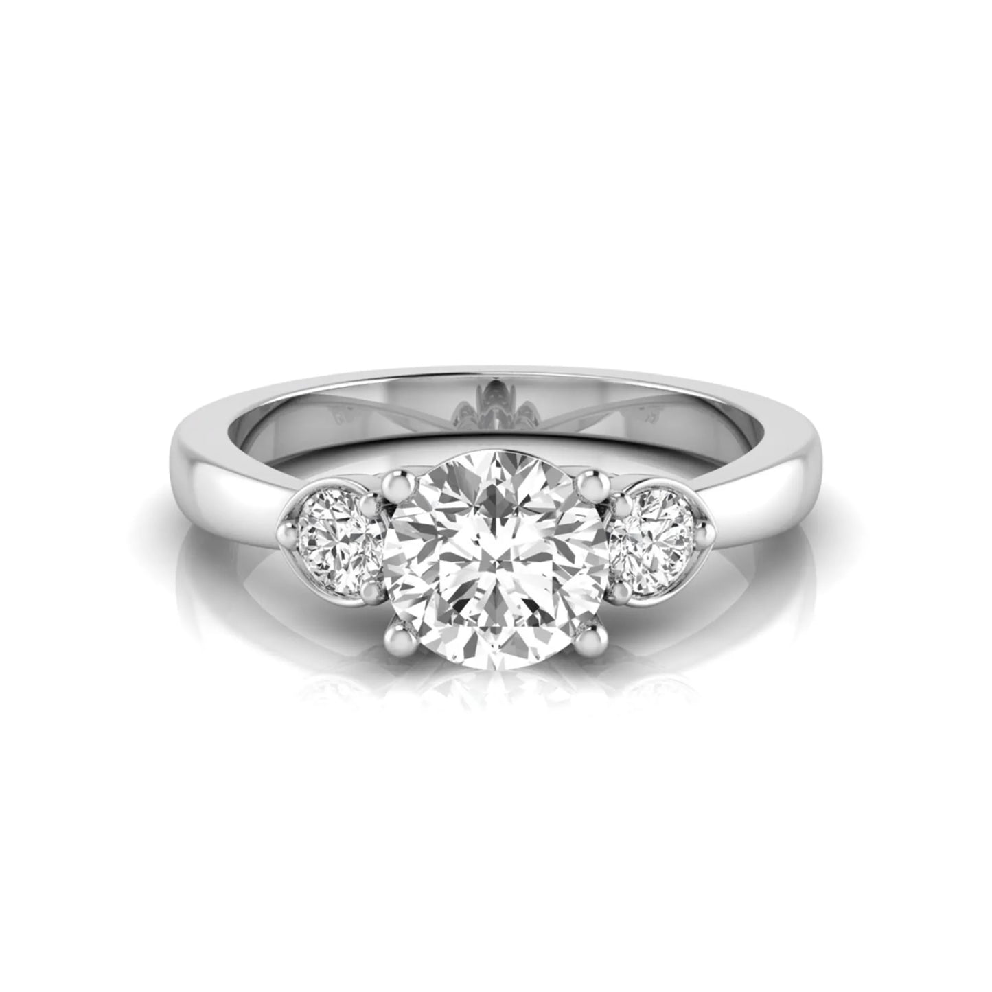 Round cut lab grown diamond three stone engagement ring featuring a brilliant center diamond with round side diamonds in a four-prong white gold tone setting.