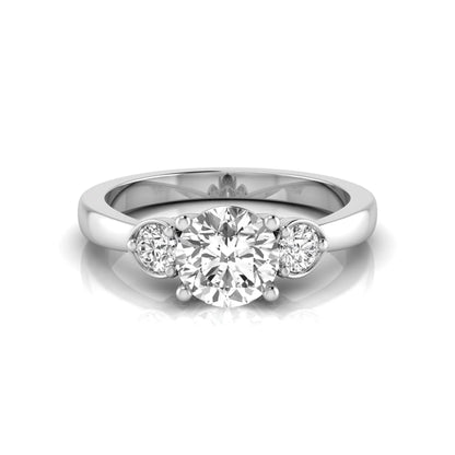 Round cut lab grown diamond three stone engagement ring featuring a brilliant center diamond with round side diamonds in a four-prong white gold tone setting.