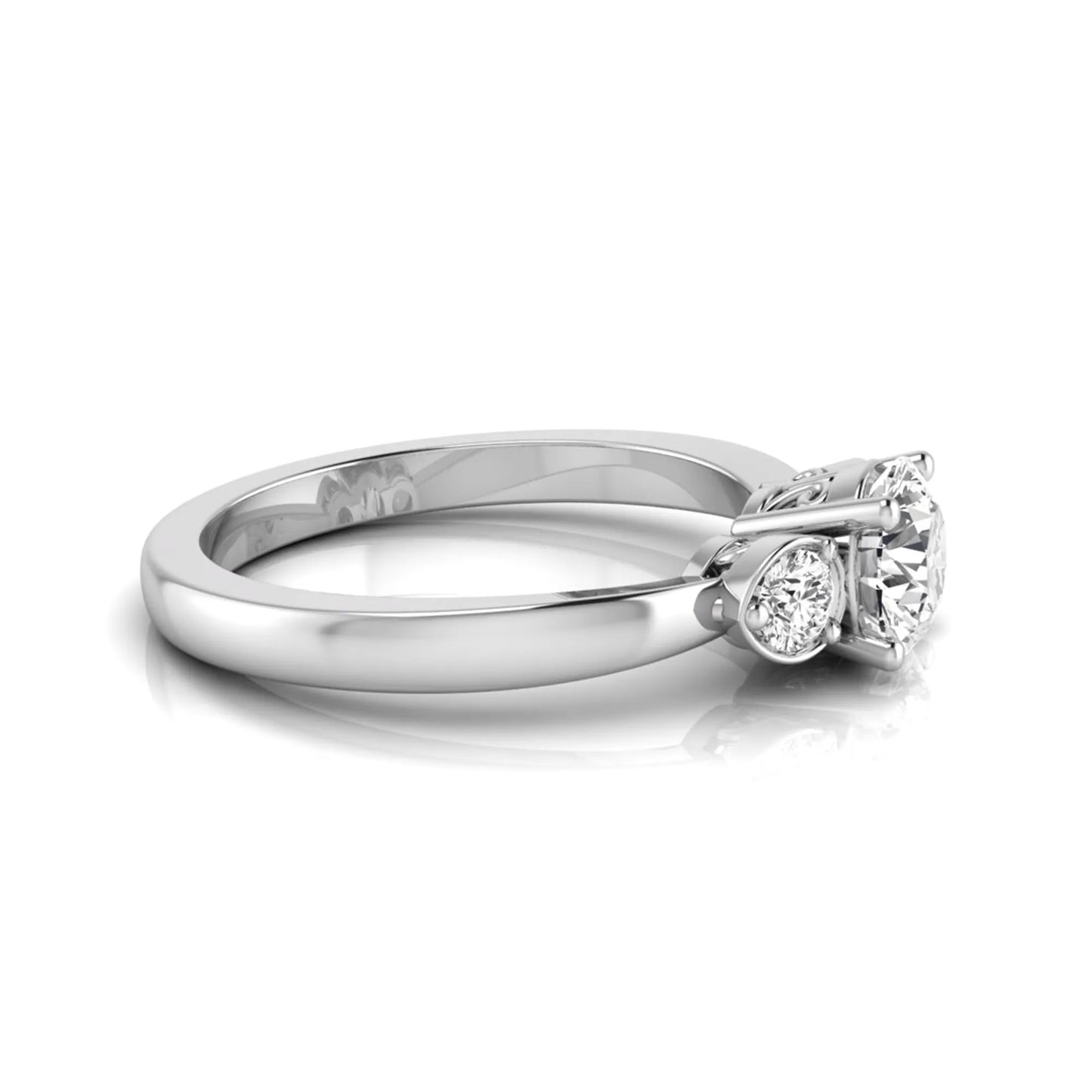 Round cut lab grown diamond three stone engagement ring featuring a brilliant center diamond with round side diamonds in a four-prong white gold tone setting.