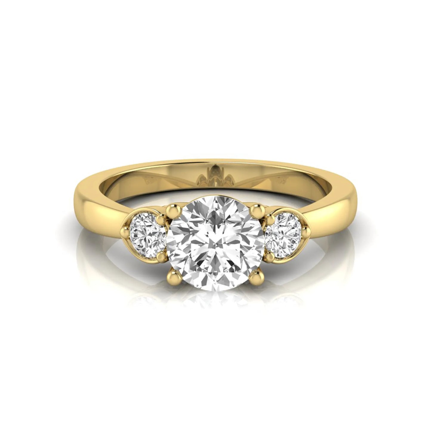Round cut lab grown diamond three stone engagement ring featuring a brilliant center diamond with round side diamonds in a four-prong yellow gold tone setting.