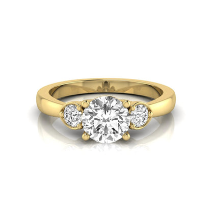 Round cut lab grown diamond three stone engagement ring featuring a brilliant center diamond with round side diamonds in a four-prong yellow gold tone setting.