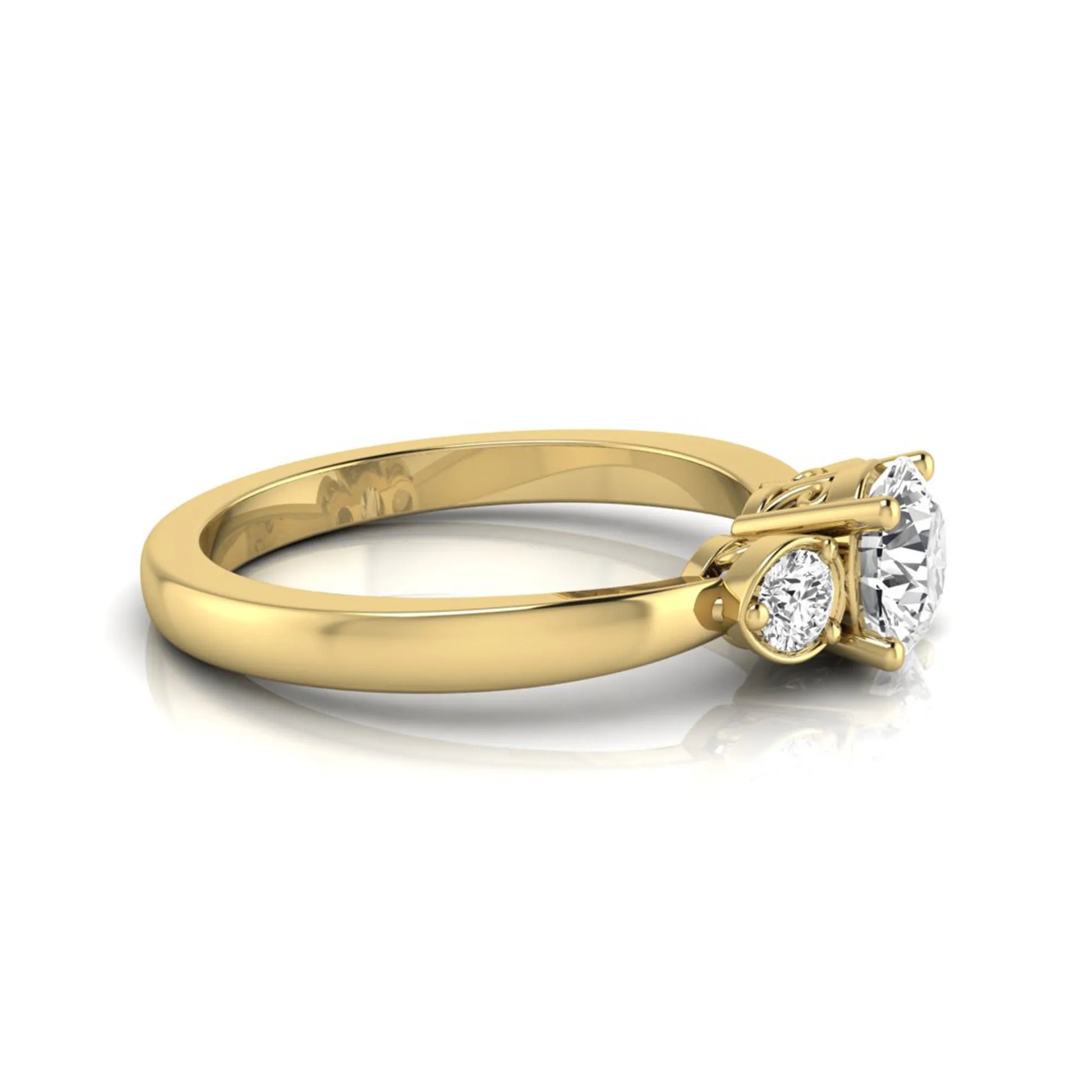Round cut lab grown diamond three stone engagement ring featuring a brilliant center diamond with round side diamonds in a four-prong yellow gold tone setting.