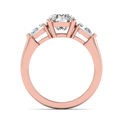 Round three stone prong set lab grown diamond engagement ring featuring a 2.00 carat round center diamond with pear cut side diamonds in rose gold finish.