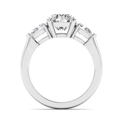 Round three stone prong set lab grown diamond engagement ring featuring a 2.00 carat round center diamond with pear cut side diamonds in white gold finish.