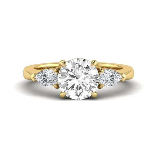 Round three stone prong set lab grown diamond engagement ring featuring a 2.00 carat round center diamond with pear cut side diamonds in yellow gold finish.