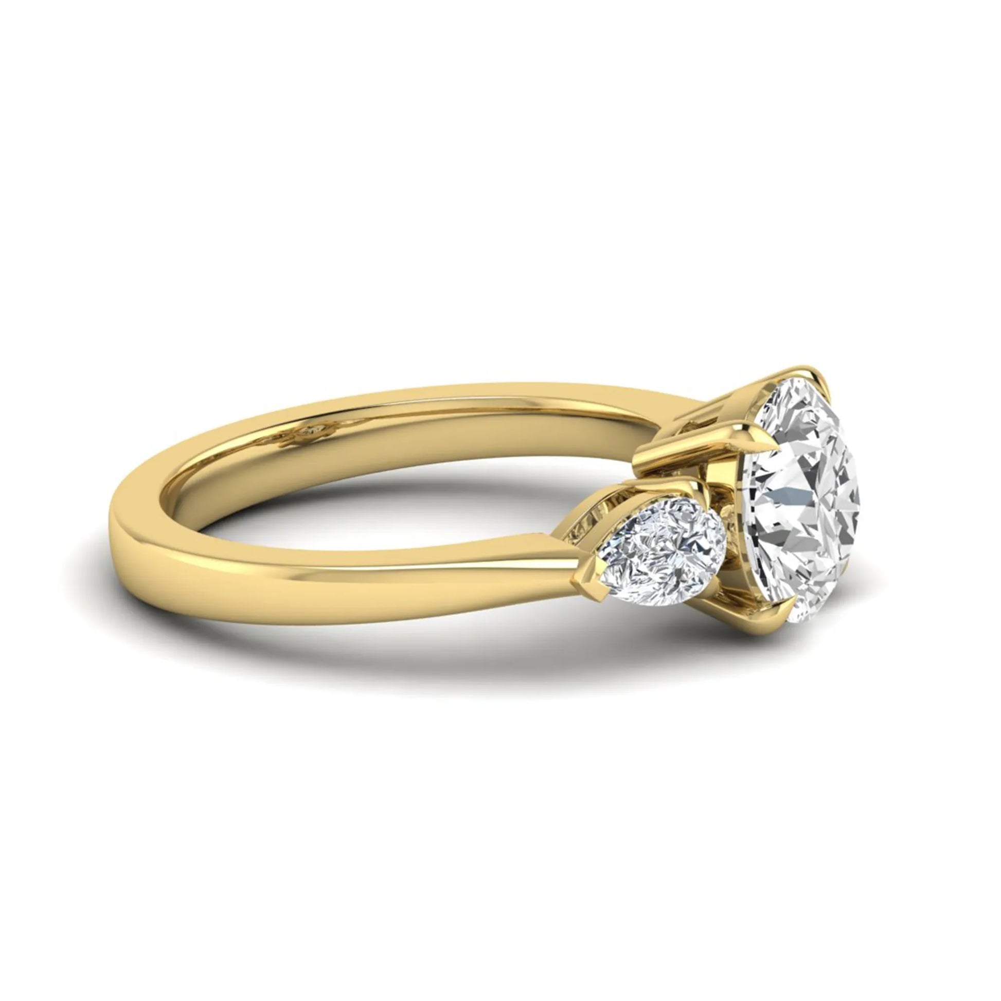 Round three stone prong set lab grown diamond engagement ring featuring a 2.00 carat round center diamond with pear cut side diamonds in yellow gold finish.