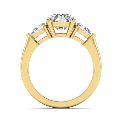 Round three stone prong set lab grown diamond engagement ring featuring a 2.00 carat round center diamond with pear cut side diamonds in yellow gold finish.